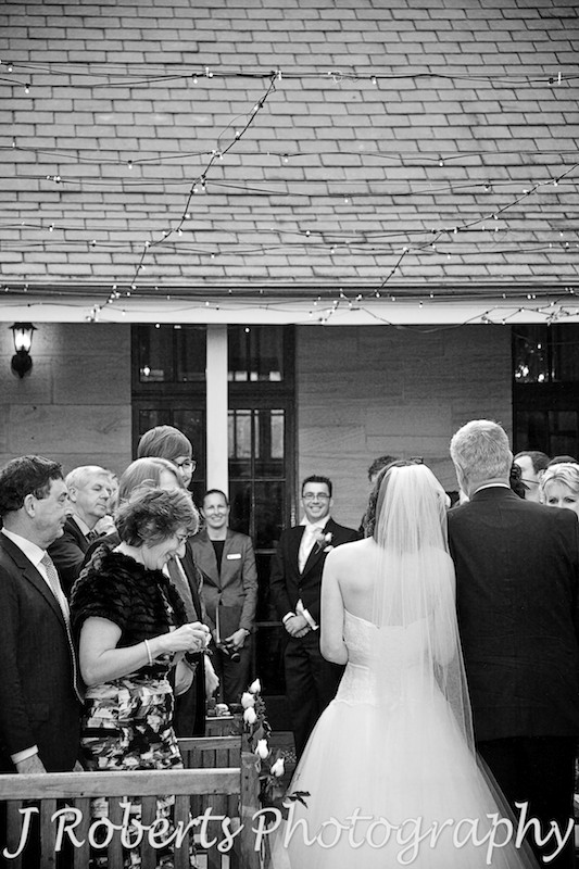 Groom looking at Bride walking down the aisle at Gunners' Barracks Courtyard - wedding photography sydney